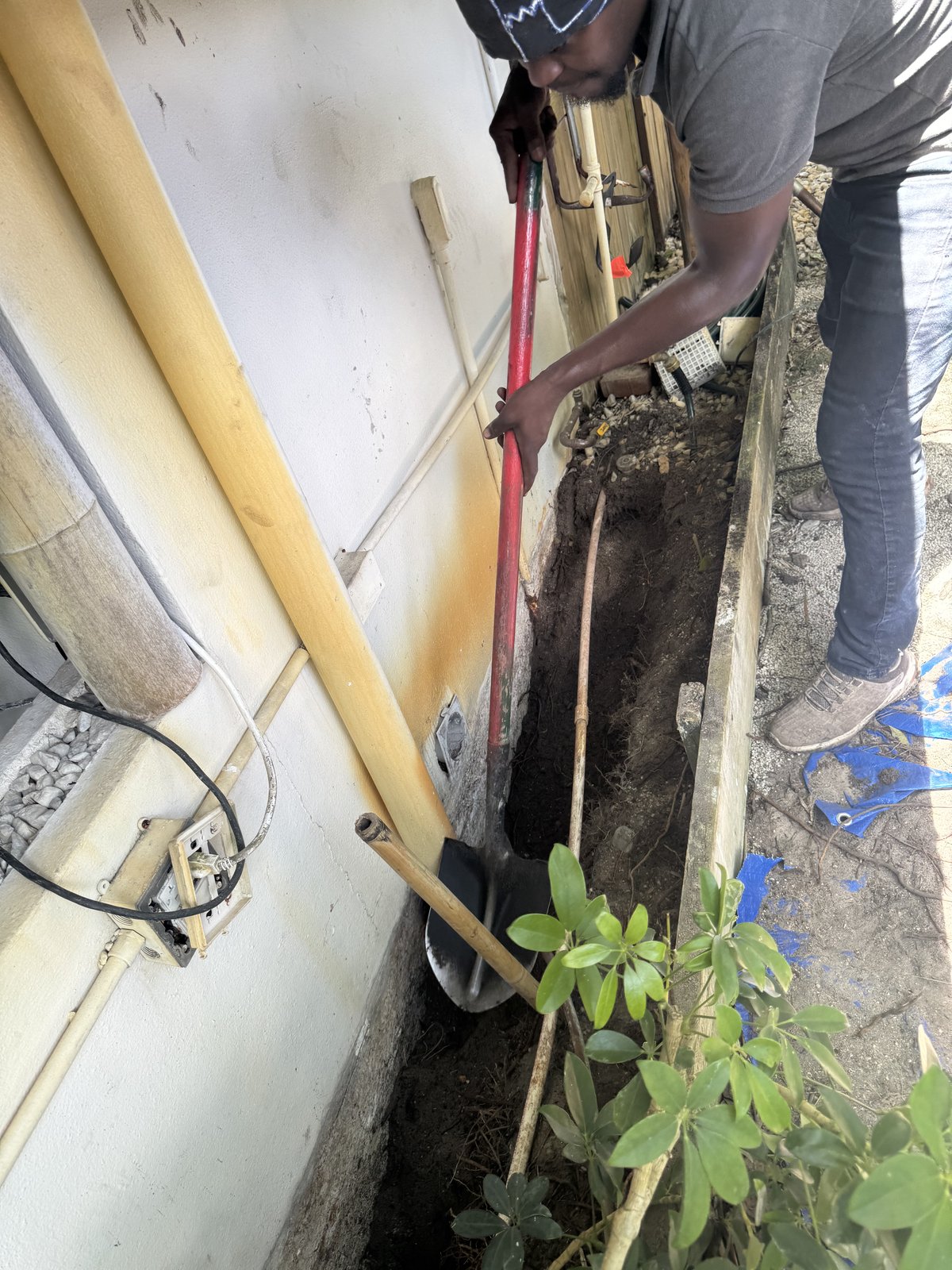 Excavating along a foundation before waterproofing in Fort Lauderdale